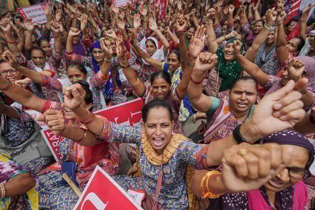 Rural child care workers shout slogans during a nationwide strike in Ahmedabad, India, Wednesday, July 9, 2025. (AP Photo/Ajit Solanki)