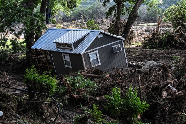 A damaged house is seen near the Guadalupe River in Hunt, Texas, on July 8, 2025, following severe flash flooding over the July 4 holiday weekend. Following deadly floods in Texas, misinformation from both left- and right-wing users was roiling social media, with liberals baselessly blaming staffing cuts at US weather agencies for flawed warning systems and conservatives ramping up conspiracy theories.
The catastrophic floods over the 4th of July weekend have left more than a 100 people dead, including more than two dozen girls and counselors at a riverside summer camp, with rescuers racing on July 8 to search for dozens of people still missing. (Photo by RONALDO SCHEMIDT / AFP) (Photo by RONALDO SCHEMIDT/AFP via Getty Images)          
