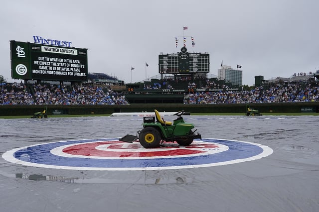 A baseball game between the Chicago Cubs and the St. Louis Cardinals is delayed due to inclement weather Sunday, July 6, 2025, in Chicago. (AP Photo/David Banks)