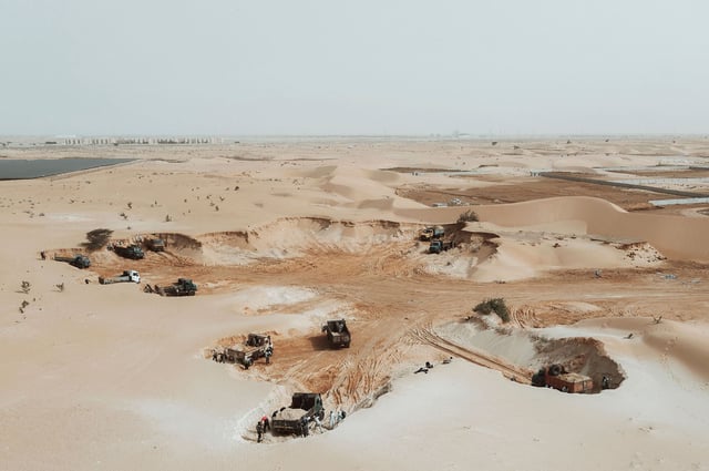 An aerial view show trucks loading sand from a quarry on the outskirts of Nouakchott, Mauritania, on March 14, 2023.
