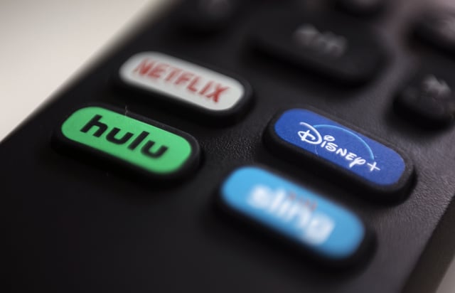 FILE - The logos for streaming services Netflix, Hulu, Disney Plus and Sling TV are pictured on a remote control on Aug. 13, 2020, in Portland, Ore. (AP Photo/Jenny Kane, File)