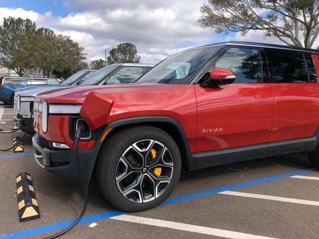 A vehicle by Rivian Automotives, the maker of all-electric SUVs and pickup trucks, charging outside the company’s service center in Mira Mesa in January 2024. (Rob Nikolewski/San Diego Union-Tribune)