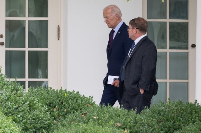 Former president Joe Biden speaks with White House physician Kevin O&#39;Connor as he arrives back at the White House in Washington, DC, on August 28, 2023.