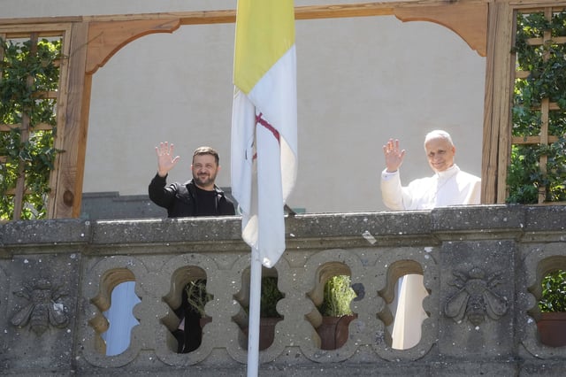 Ukraine President Volodymyr Zelenskyy, left, and Pope Leo XIV wave to journalists during their meeting in Castel Gandolfo, Italy, Wednesday, July 9, 2025. (AP Photo/Gregorio Borgia)
