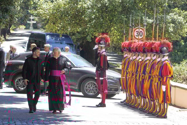 Ukraine President Volodymyr Zelenskyy, left, walks with Father Lorenzo Sapienza past Swiss guards ahead of his meeting with Pope Leo XIV in Castel Gandolfo, Italy, Wednesday, July 9, 2025. (AP Photo/Gregorio Borgia)