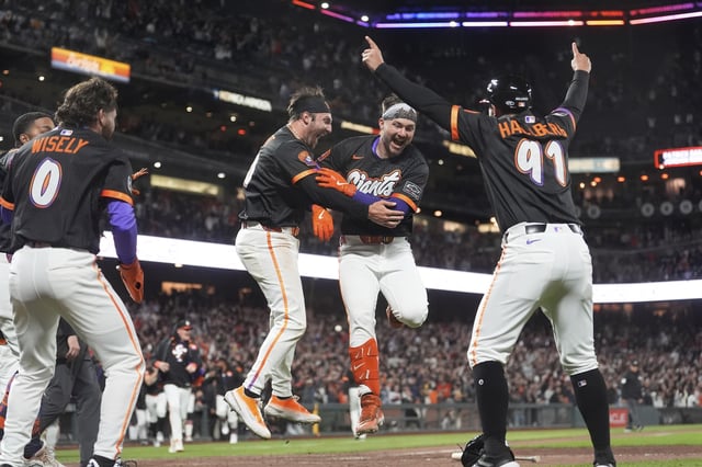 San Francisco Giants' Patrick Bailey, middle right, celebrates with teammates after hitting a three-run inside the park home run during the ninth inning of a baseball game to defeat the Philadelphia Phillies in San Francisco, Tuesday, July 8, 2025. (AP Photo/Jeff Chiu)