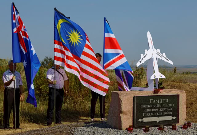 People hold flags at a memorial to victims of the Malaysia Airlines Flight MH17 plane crash during a ceremony marking the 10th anniversary of the accident, near the village of Hrabove (Grabovo) in the Donetsk region, Russian-controlled Ukraine, July 17, 2024. REUTERS/Alexander Ermochenko/File Photo