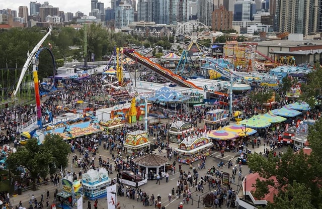 Crowds flock to the midway at the Calgary Stampede on Sunday, July 7, 2019. Stampede officials say they plan to bring in enhanced safety protocols — including potentially requiring proof of a COVID-19 vaccination at some venues — if the 10-day event goes ahead. THE CANADIAN PRESS/Jeff McIntosh