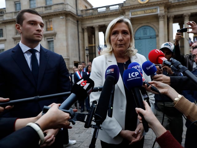 PARIS, FRANCE - OCTOBER 19: French far-right party Rassemblement National (RN) leader and Member of Parliament Marine Le Pen and Jordan Bardella speak to the media after observing a minute of silence for a murdered 12-year-old schoolgirl, named Lola, whose body was discovered in a trunk in the 19th district, in Paris, on October 20, 2022 in Paris, France. The brutalised body of the victim, identified only as "Lola" under French law, was found in a plastic box after going missing in northeast Paris last week. A 24-year-old woman from Algeria was quickly identified as the main suspect and detained. Police have determined she had a history of psychiatric disorders. (Photo by Antoine Gyori/Corbis via Getty Images)