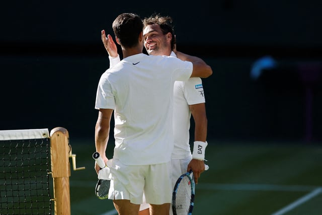 Tennis - Wimbledon - All England Lawn Tennis and Croquet Club, London, Britain - June 30, 2025 Spain's Carlos Alcaraz and Italy's Fabio Fognini embrace after their first round match REUTERS/Stephanie Lecocq     TPX IMAGES OF THE DAY