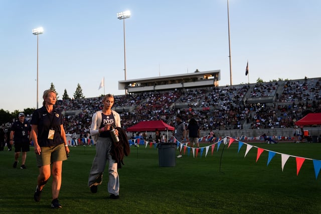 AB Hernandez, second left, a transgender student at Jurupa Valley High School, leaves the stadium after competing in the triple jump at the California high school track-and-field championships in Clovis, California, on May 30.