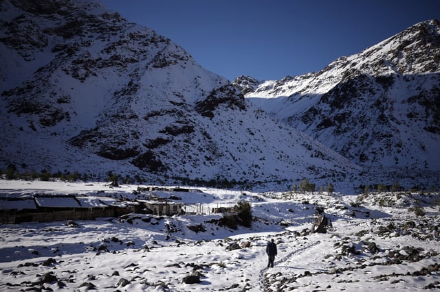 Sheep farmers Raul Aguiar and Abelardo Rios walk through the snow back to their home in the Chilean Andes, where glaciers are facing the risk of rising temperatures, at a zone named Cajon del Maipo in San Jose de Maipo, Chile June 24, 2025. REUTERS/Pablo Sanhueza