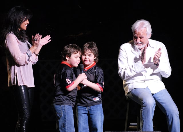 Kenny Rogers onstage with his wife Wanda Rogers and their twin sons Justin and Jordan on Feb. 12, 2011 in Athens, GA.