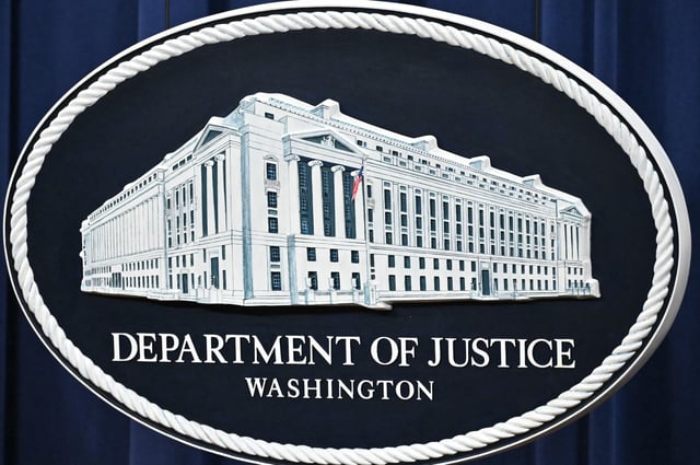 A logo for the US Department of Justice is seen before the start of a press conference on health care fraud enforcement at the Department of Justice in Washington, DC on June 30, 2025.