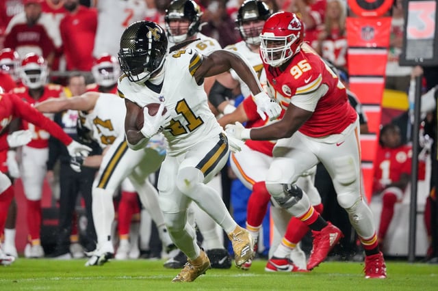 Oct 7, 2024; Kansas City, Missouri, USA; New Orleans Saints running back Alvin Kamara (41) runs the ball as Kansas City Chiefs defensive tackle Chris Jones (95) chases during the game at GEHA Field at Arrowhead Stadium. Mandatory Credit: Denny Medley-Imagn Images