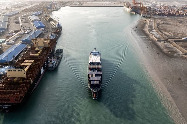 This aerial view shows a container ship cruising at the port of Umm Qasr in Iraq's southern city of Basra. Iraq was among the latest countries to receive a letter from President Donald Trump informing the nation of the rate its goods will be tariffs come August 1 at absent a trade deal.