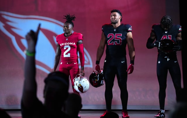 Cardinals players Hollywood Brown (2), Zaven Collins and Myjai Sanders (41) show off new uniforms during a first look.