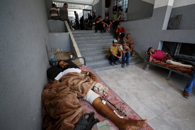 Wounded Palestinians lie on beds at Al-Shifa Hospital, which Gaza's health ministry says is at risk of shutting down due to the Israeli blockade of fuel, in Gaza City July 9, 2025. REUTERS/Mahmoud Issa