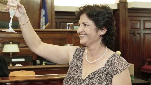 Mandonna &#34;Donna&#34; Kashanian, 64, holds up a champagne glass.