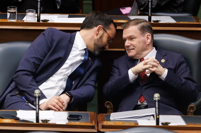 MPPs Nolan Quinn, left, and Todd McCarthy wait for the announcement of the new speaker of the Ontario legislature at Queen's Park in Toronto, Monday, April 14, 2025.