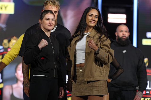 Katie Taylor and Amanda Serrano pose in front of Jake Paul during a press conference ahead of their boxing match at Madison Square Garden.