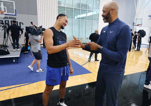 The Orlando Magic announce their newest draftees during a press conference at the AvdentHealth Training Center in Orlando on Friday, June 27, 2025. Following the press conference, Orlando guard Jalen Suggs, left, shares a moment with head coach Jamahl Mosley. (Stephen M. Dowell/Orlando Sentinel)