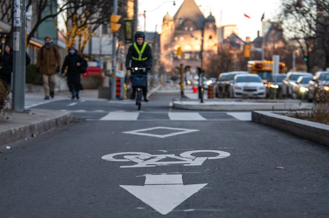 A cyclist rides in a bike lane on University Avenue in Toronto on Friday, Dec. 13, 2024. THE CANADIAN PRESS/Laura Proctor