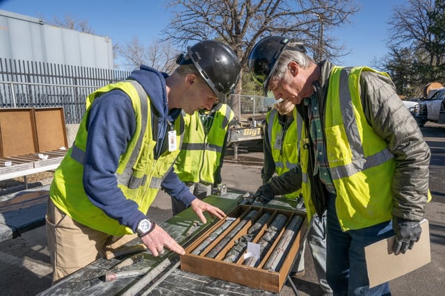 James Hagadorn, left, and Bob Raynolds examine a drilling core from the City Park core drilling in the parking lot at Denver Museum of Nature and Science. Crews found a partial-bone fossil of a 67.5 million-year-old dinosaur during a drilling project in Jan. 2025. (Courtesy of the Denver Museum of Nature and Science)