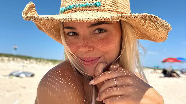 Livvy Dunne smiles for a selfie on the beach.