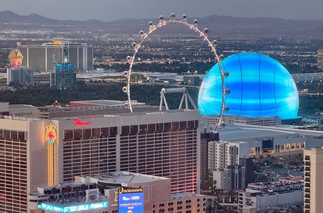 The High Roller Observation Wheel and the MSG (Madison Square Garden) Sphere lit up in blue are seen in Las Vegas, Nevada on July 3, 2025.