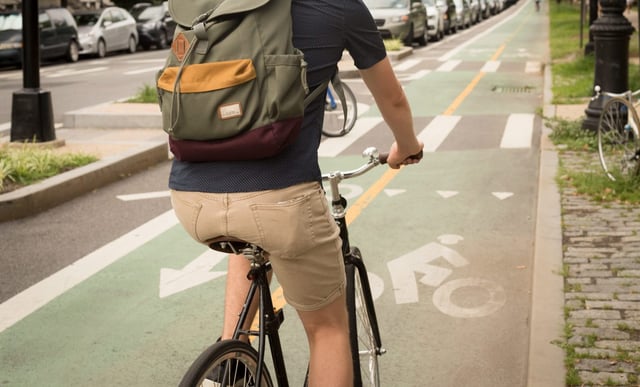 A person rides a bike in a protected lane in Brooklyn in this undated photo. (Shutterstock)
