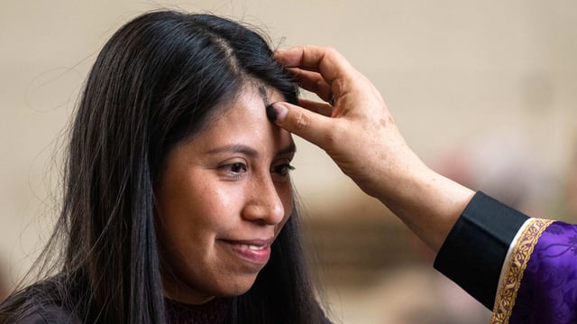 Maleni Conde receives ashes on her forehead from Diocese of San Bernardino Bishop Alberto Rojas on Feb. 22, 2023, during a mass in the chapel in Colton, Calif. Photo: Watchara Phomicinda/MediaNews Group/The Press-Enterprise via Getty Images