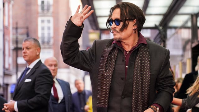 Johnny Depp poses upon arrival at the premiere of the film Modigliani Three Days On The Wing Of Madness on Tuesday