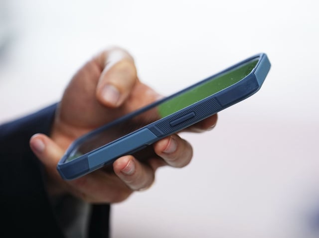 A person uses a cell phone in Ottawa on Monday, July 18, 2022.  THE CANADIAN PRESS/Sean Kilpatrick