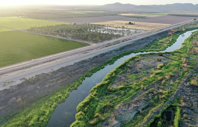An aerial view of the Colorado River as it flows past farmland along the border between California and Arizona near Yuma, Ariz., on May 25, 2023. 