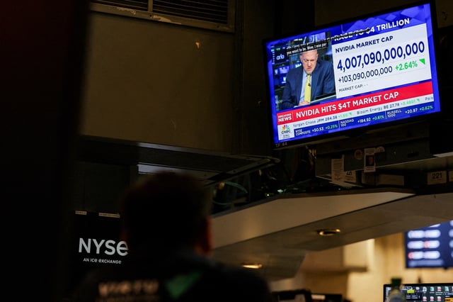 A screen displays news on "Nvidia hits $4T market cap" on the floor at the New York Stock Exchange (NYSE) in New York City, U.S., July 9, 2025. REUTERS/Jeenah Moon