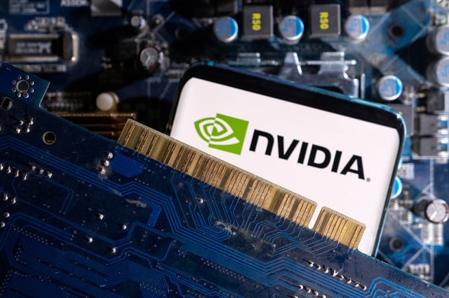 A smartphone with a displayed NVIDIA logo is placed on a computer motherboard in this illustration taken March 6, 2023. REUTERS/Dado Ruvic/Illustration/ File Photo