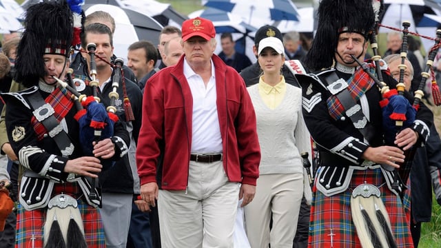 Donald Trump, escorted by Scottish pipers, at the opening of the Trump International Golf Links course in Aberdeenshire in 2012