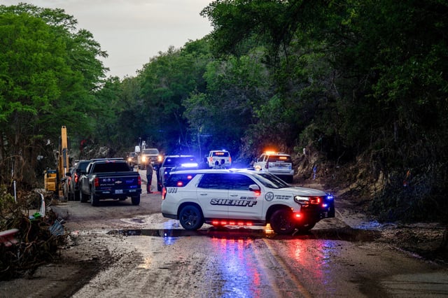 Law enforcement work to retrieve a deceased person near Camp Mystic in Hunt, Texas, on July 7, 2025.