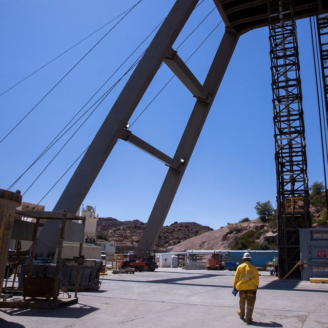 FILE PHOTO: A mine worker walks toward the mine shaft at the Resolution Copper exploratory mine shaft 10 facility in Superior, Arizona, U.S., March 30, 2021. Picture taken March 30, 2021.  REUTERS/Caitlin O'Hara/File Photo