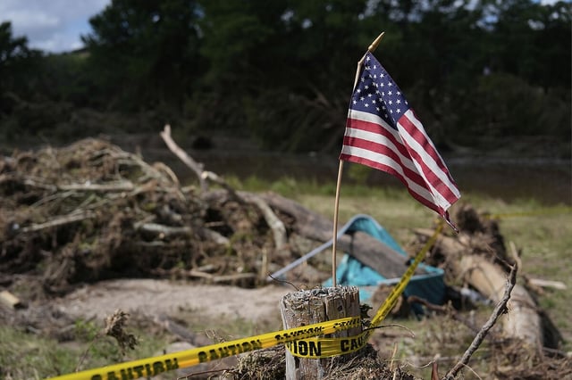 An American flag is placed on a stump amid debris in Kerrville, Texas, July 8, 2025.