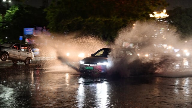 Vehicles wade through a waterlogged road amidst heavy rainfall, at Moti Bagh in New Delhi on July 9.