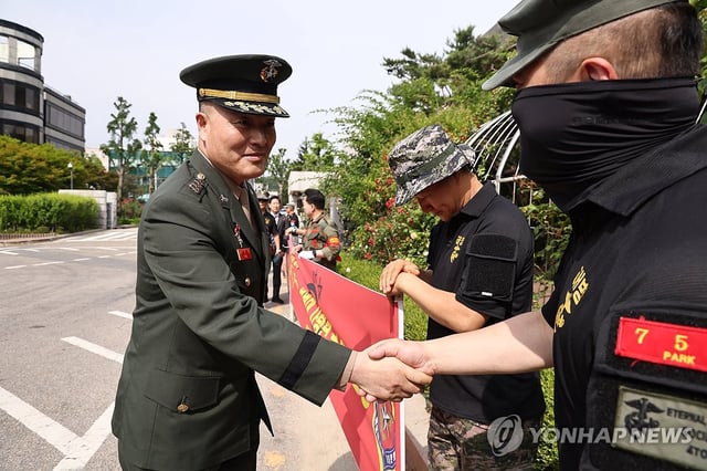 In this file photo, Park Jung-hun, a former Marine Corps chief investigator, shakes hands with his supporters before attending a hearing at the Seoul High Court in the capital on June 13, 2025. (Yonhap)
