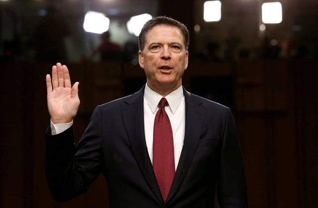 FILE PHOTO: Former FBI Director James Comey is sworn in prior to testifying before a Senate Intelligence Committee hearing on Russia&#39;s alleged interference in the 2016 U.S. presidential election on Capitol Hill in Washington, U.S., June 8, 2017. REUTERS/Jonathan Ernst//File Photo