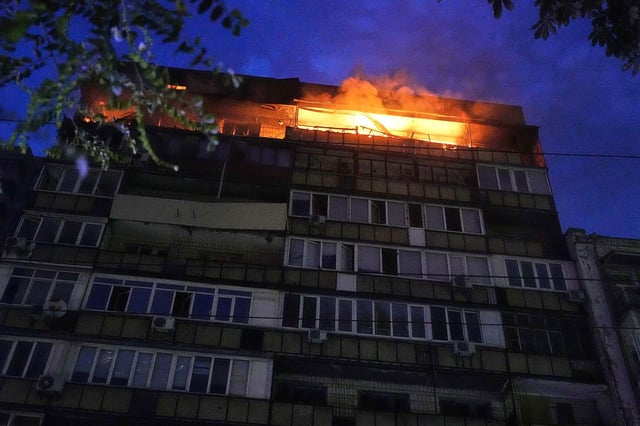 A fire burns at a residential building in Kyiv, Ukraine, after a Russian attack early Thursday morning.