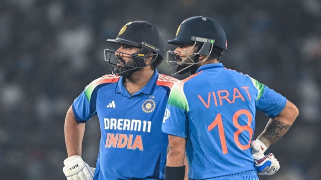 India's Virat Kohli (R) along with his captain Rohit Sharma