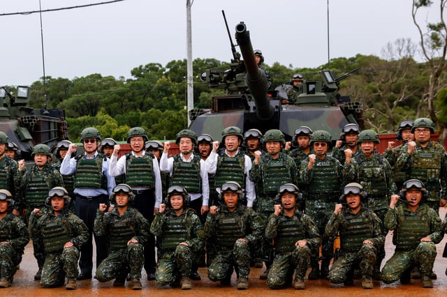 Taiwan's President Lai Ching-te poses for a group photo in front of U.S.-made M1A2T Abrams tanks after taking part in live-fire exercises in Hsinchu, Taiwan July 10, 2025. REUTERS/Ann Wang