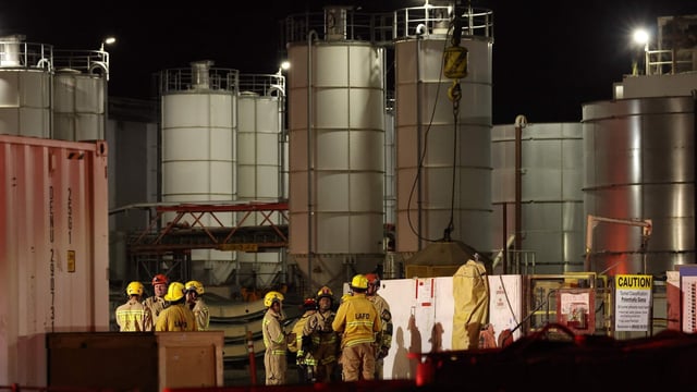 Los Angeles Fire Department (LAFD) firefighters are seen at the site of an industrial tunnel collapse in the Wilmington neighborhood of Los Angeles on July 9, 2025. 31 workers were safely removed from the tunnel without visible injuries, the LAFD said on July 9. (Photo by Patrick T. Fallon / AFP)