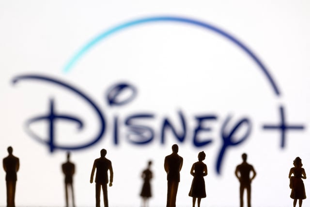 Toy figures of people are seen in front of the displayed Disney + logo, in this illustration taken January 20, 2022. REUTERS/Dado Ruvic/Illustration/File photo