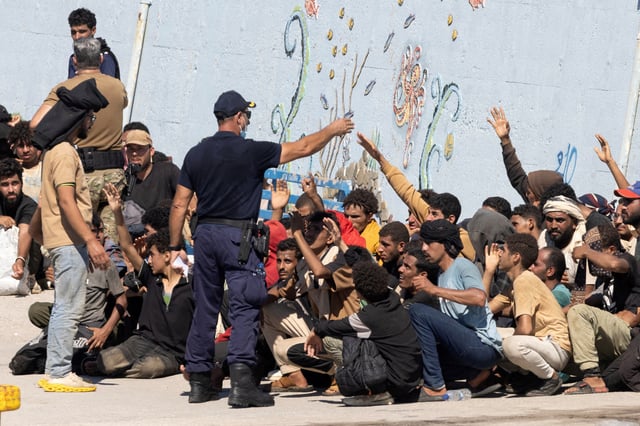 Migrants talk with the authorities, after Greece rescued hundreds of migrants off the islands of Gavdos and Crete in separate incidents, according to the Greek Coast Guard, in the port of Agia Galini, Greece, July 6, 2025. REUTERS/Stefanos Rapanis/File Photo
